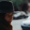 woman in black hat standing near white car during daytime